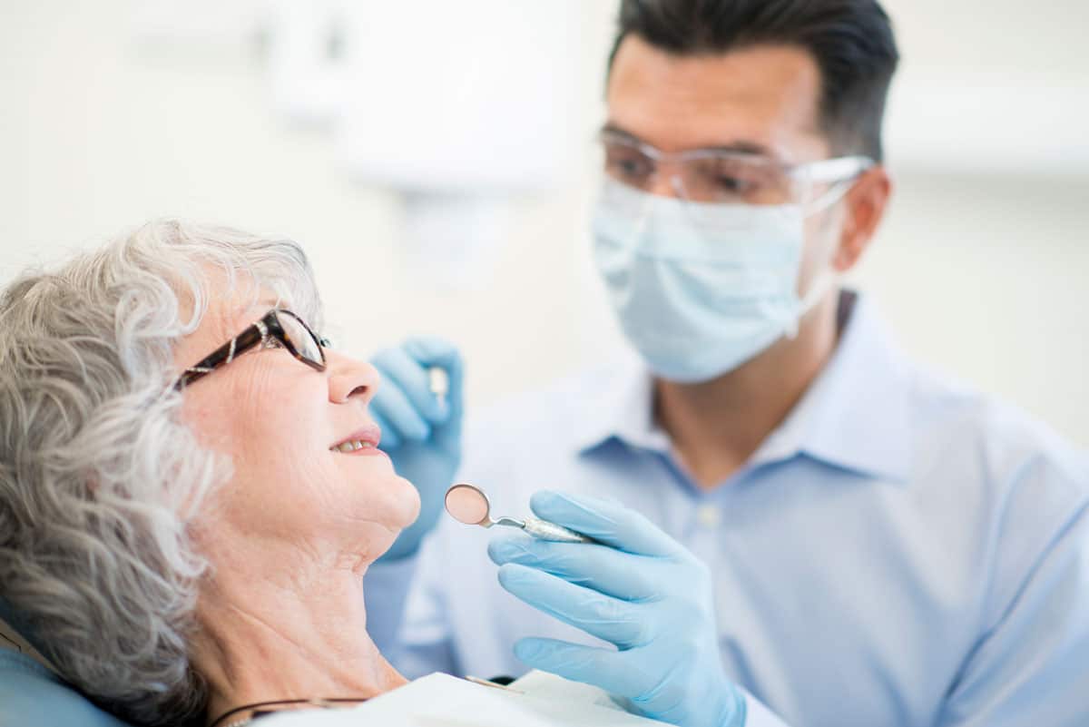 dentist working with senior female patient