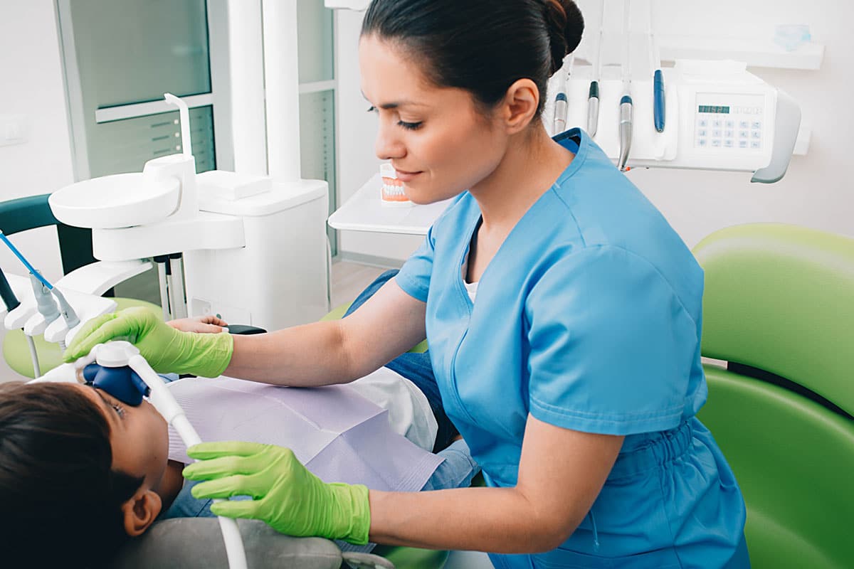 dental assisting giving nitrous oxide to child