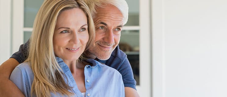 older couple, man with arms around woman